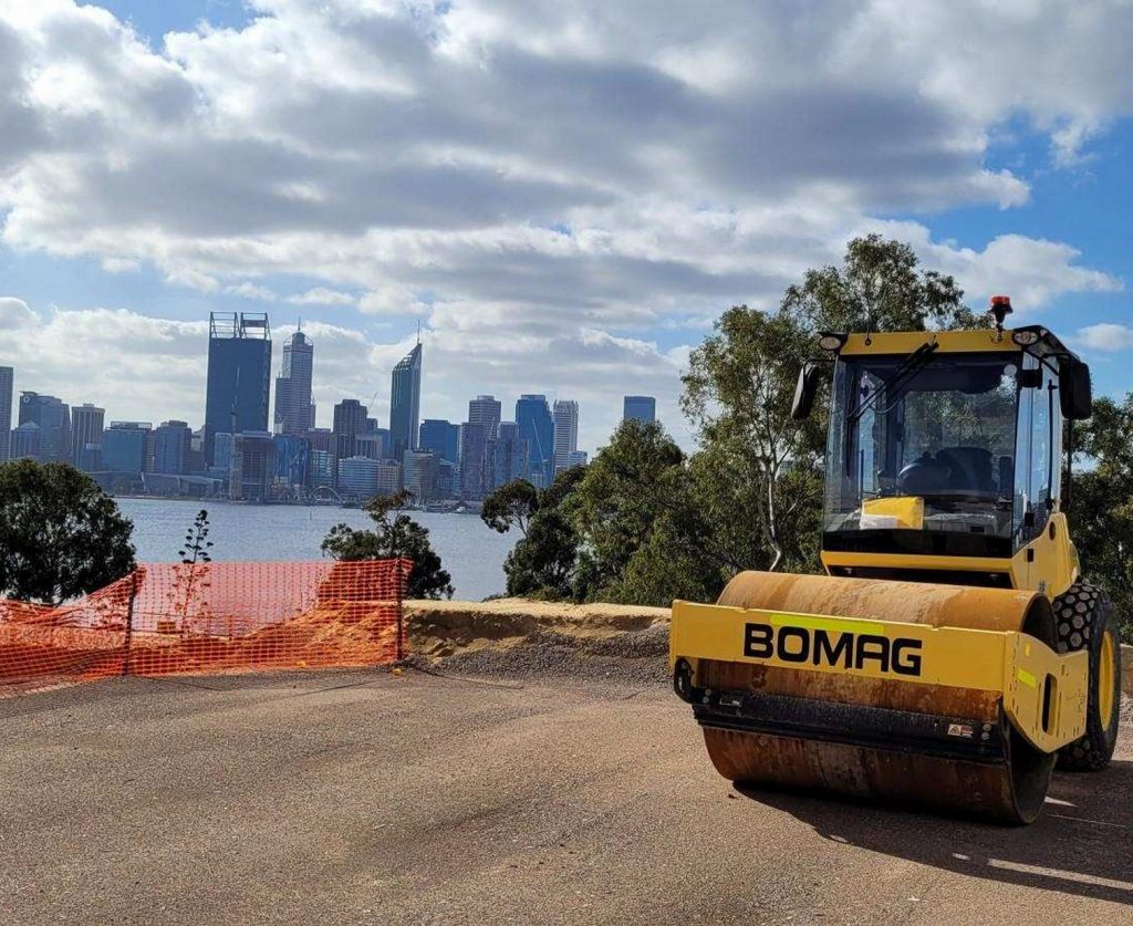 Bomag Smooth drum roller for hire on city skyline